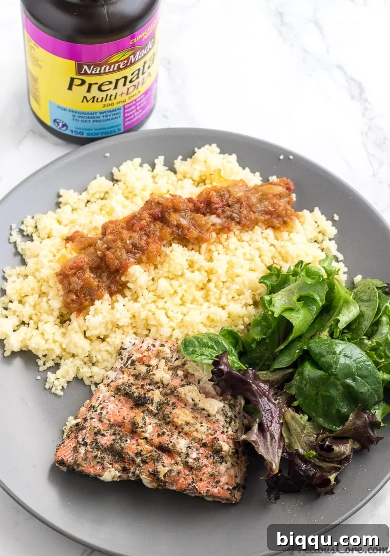 Healthy grilled salmon served with green veggies, couscous.