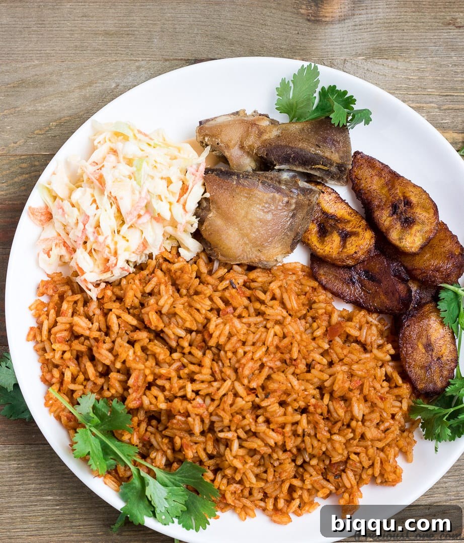 Overhead view of Nigerian Jollof Rice cooking in a pot, showing rich red color