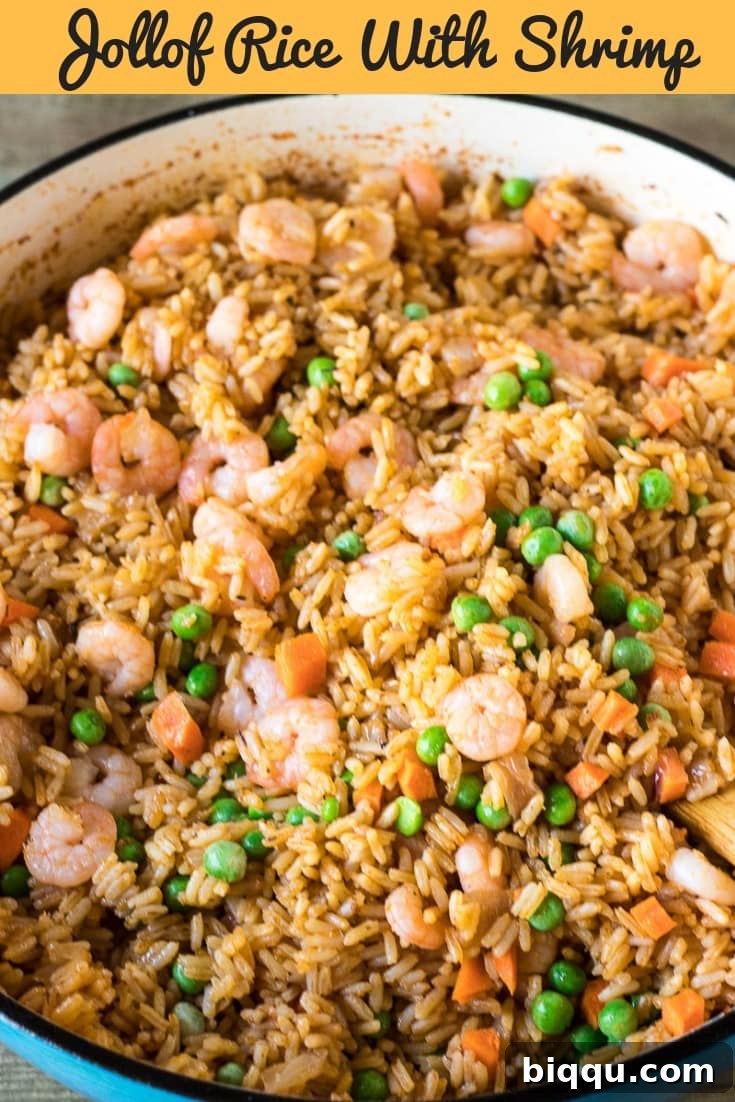 Pot of rice mixture with text "Jollof Rice with Shrimp" - Pin for later