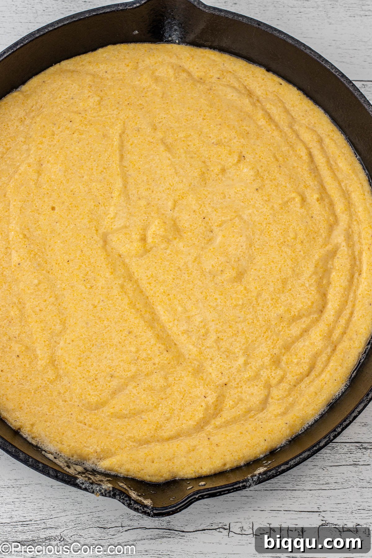 Fluffy Cornbread Without Buttermilk 8 Cornbread batter in cast iron skillet.