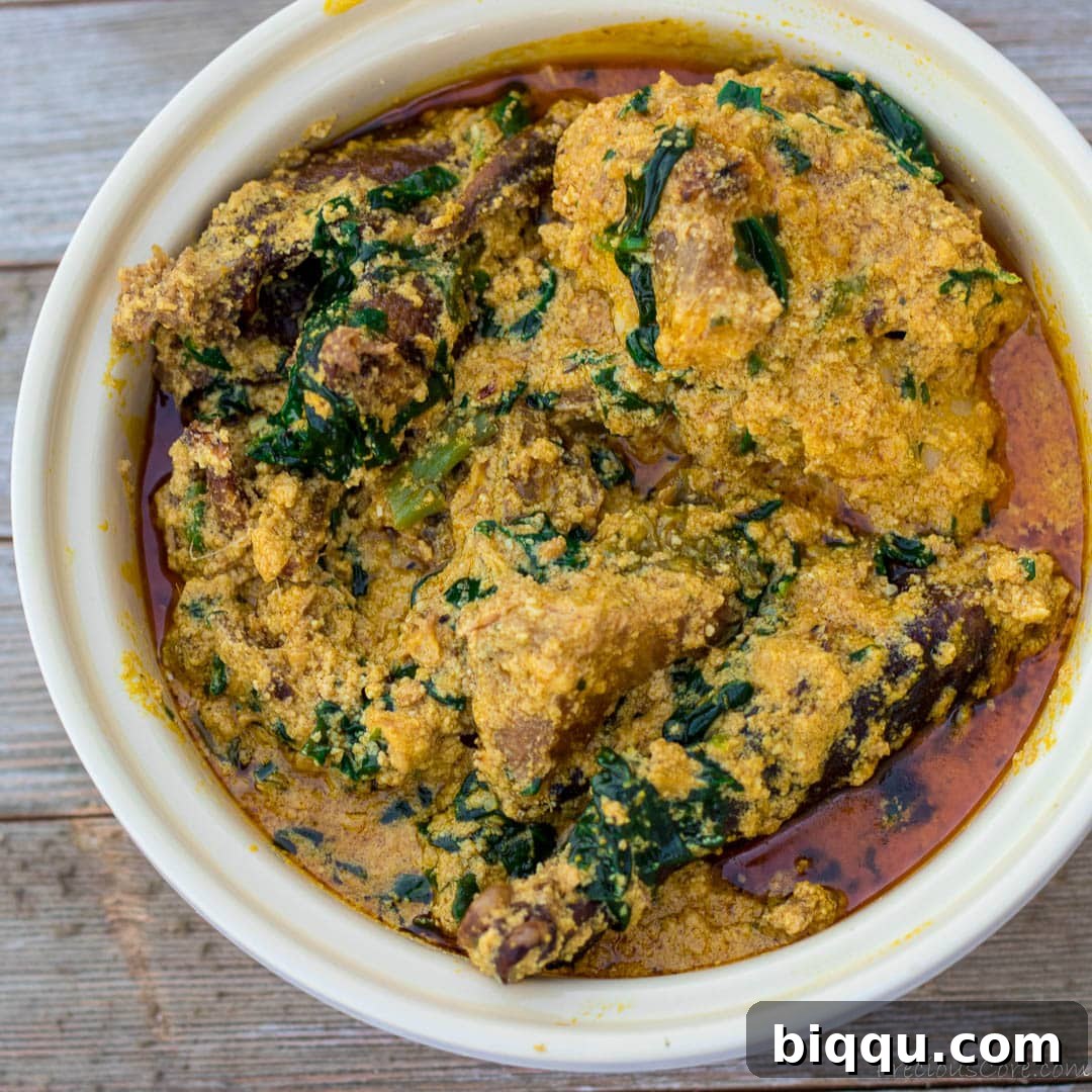 Nigerian Egusi Soup in a round white bowl, ready to be served.