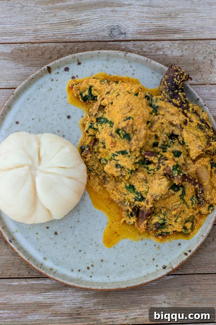 Egusi soup and pounded yam on a plate, a classic Nigerian meal.