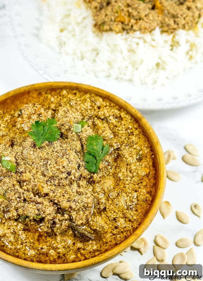 Egusi Stew in a rustic wooden bowl, showcasing its thicker consistency.