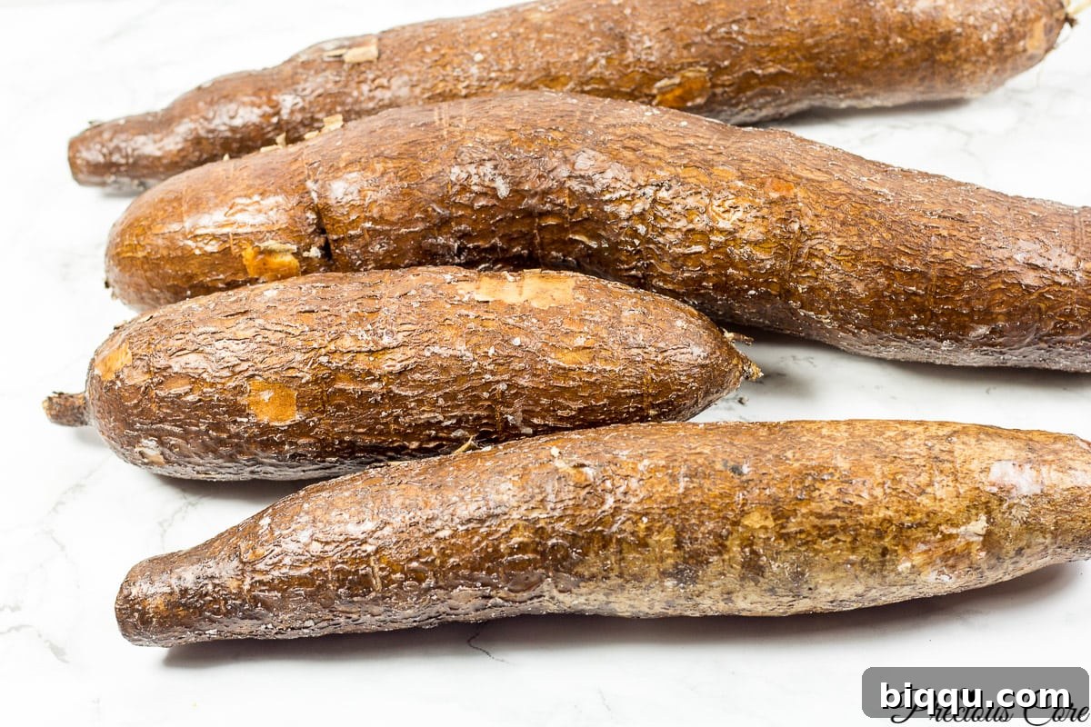 Four cassava roots on a wooden counter, showcasing their rustic appeal.