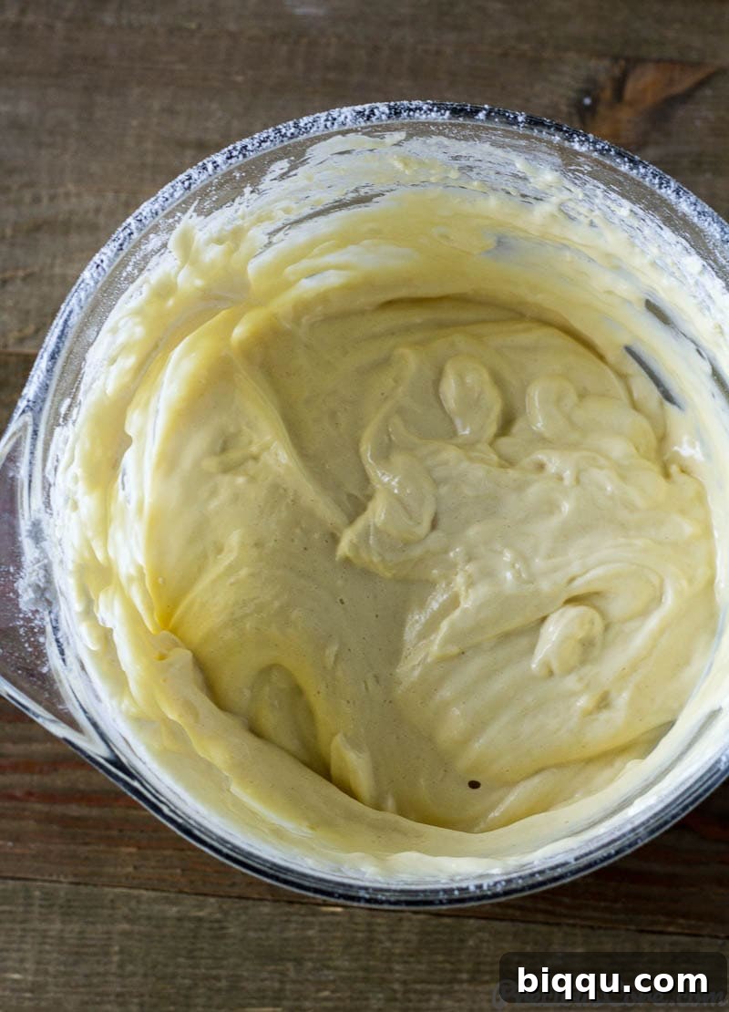 Fluffy Vanilla Sponge Cake 6 Smooth, light yellow vanilla sponge cake batter in a mixing bowl.