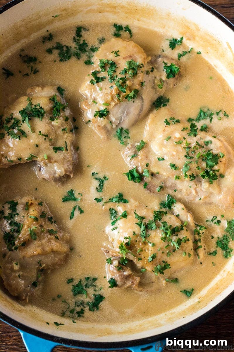Chicken in creamy white sauce simmering in a pot