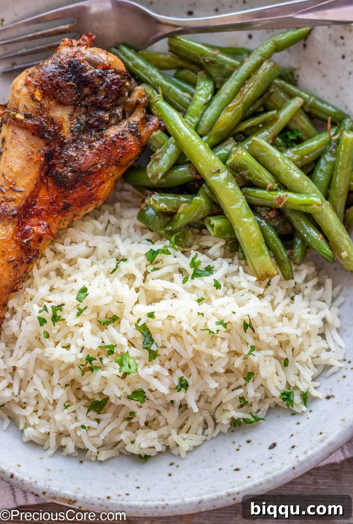 Individual turkey wing served with fragrant garlic herb rice and tender green beans.