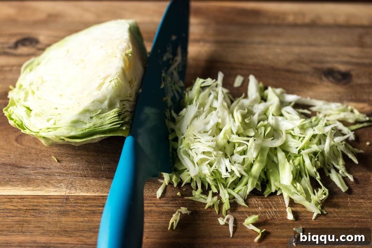 Zesty Cabbage Delight 5 how to chop cabbage, illustrating the shredding process.