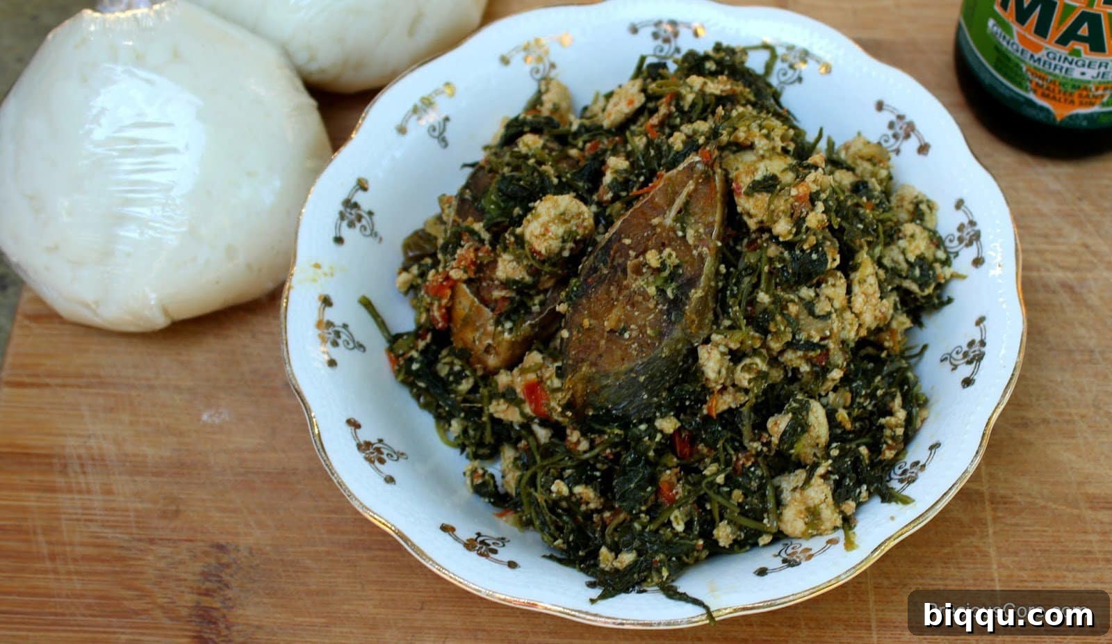 Njama Njama with Egusi in a white bowl.