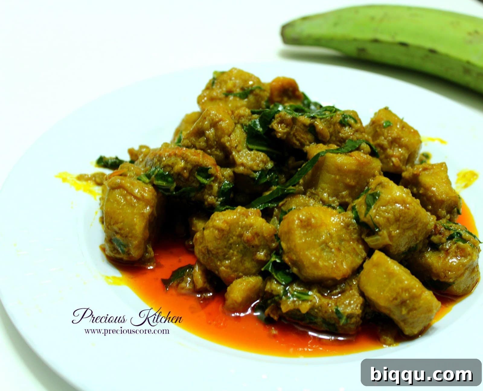 Hearty Sese Plantains Porridge Delicious Sese Plantains served in a bowl, showcasing the vibrant colors of palm oil and greens, a traditional Cameroonian dish.