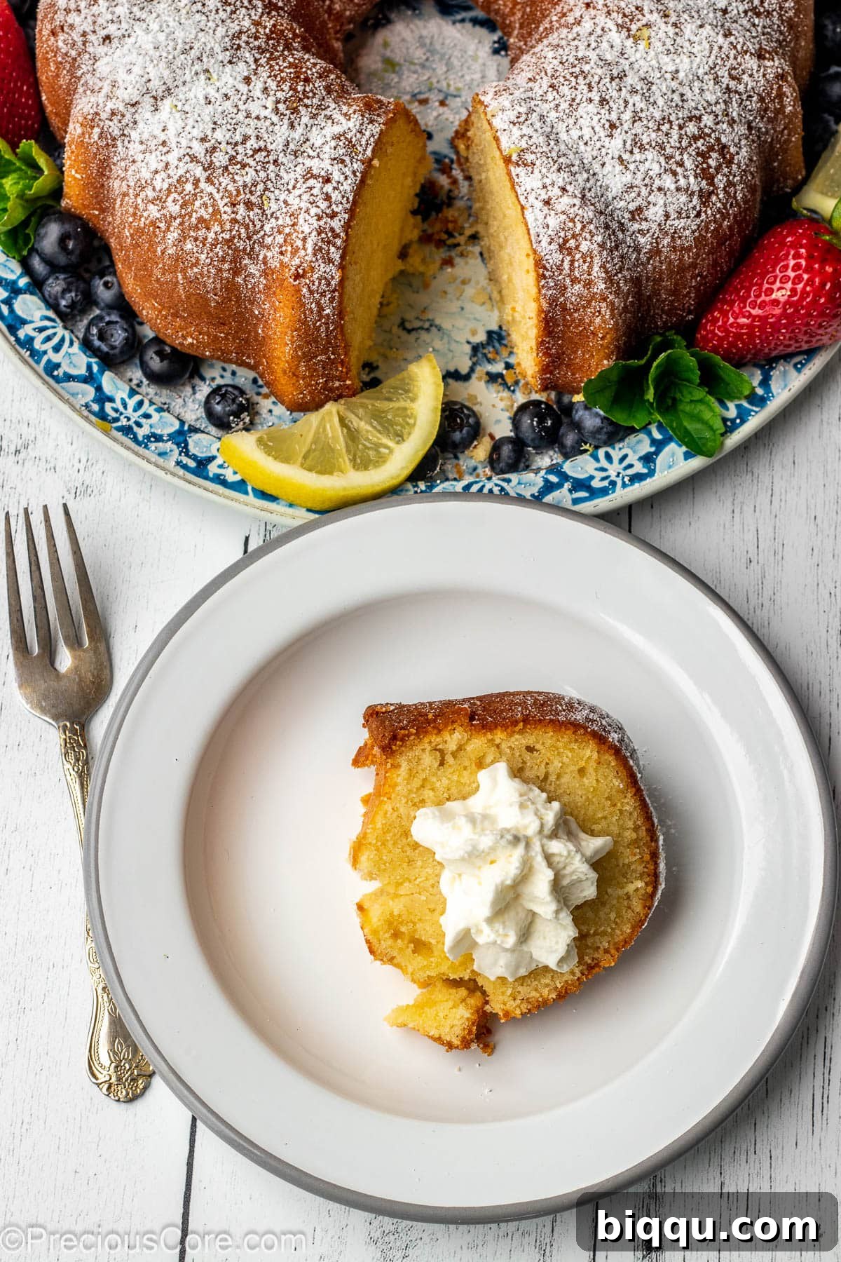 A slice of pound cake topped with whipped cream. 
