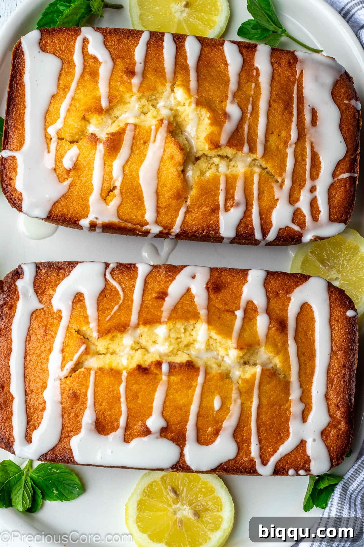 Two loaf cakes with drizzles of lemon glaze on top.