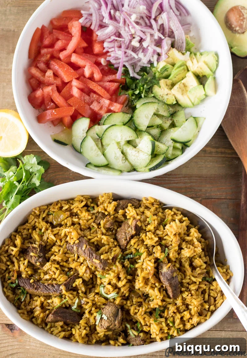 Bowl of savory Beef Pilau next to a fresh bowl of Kenyan Kachumbari salad and vegetables.