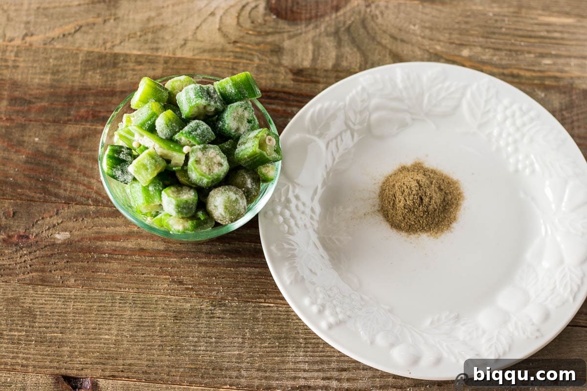 Bowl of sliced okra next to a container of gumbo file powder, highlighting two traditional gumbo thickeners.