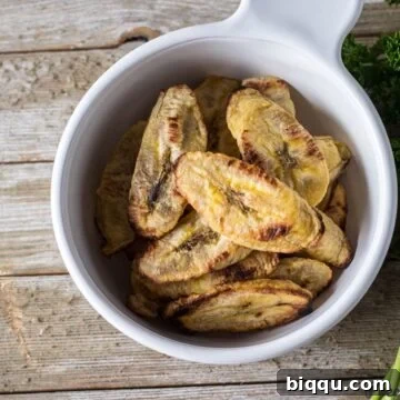A close-up image of a perfectly baked plantain slice, golden and caramelized