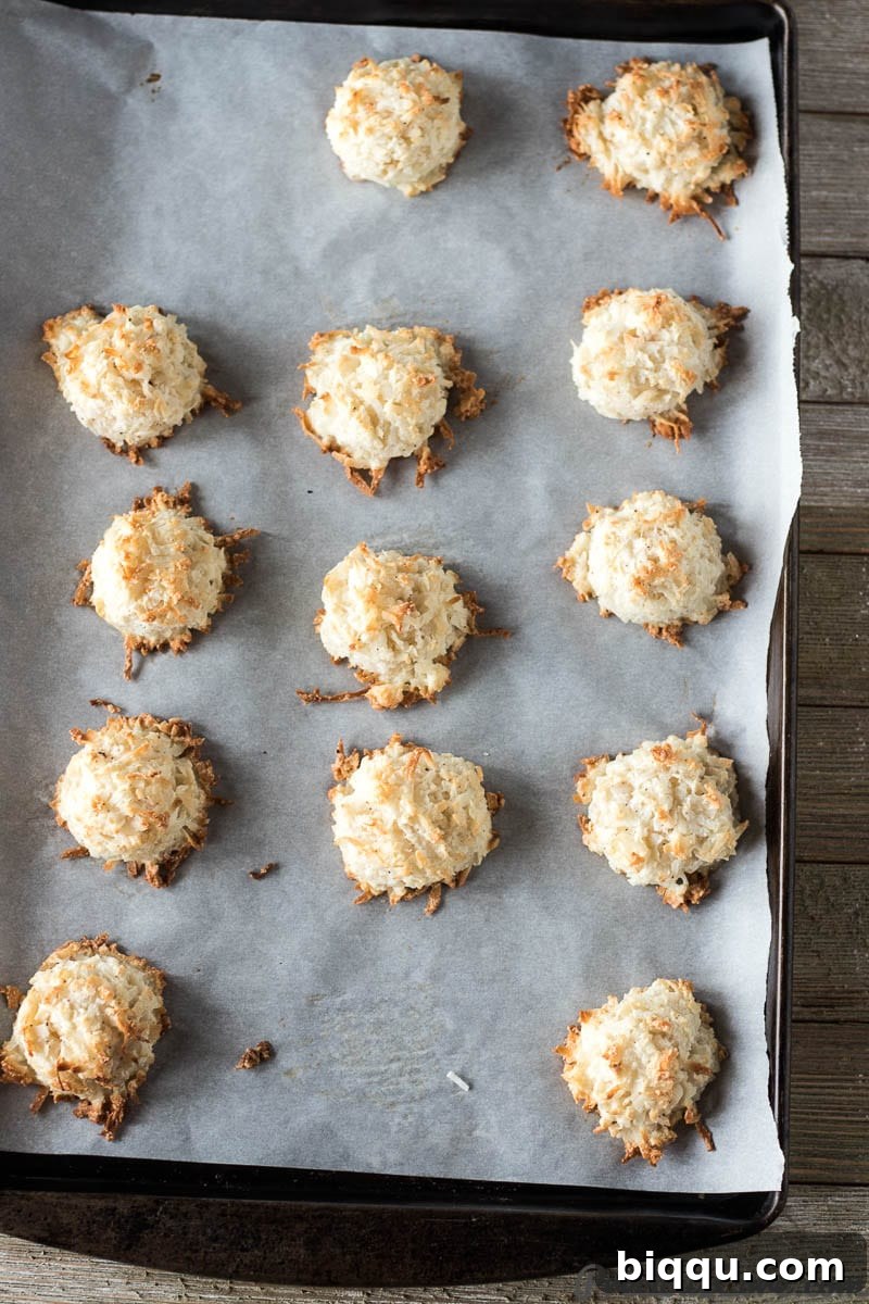 Baked easy coconut macaroons on baking sheet lined with parchment paper