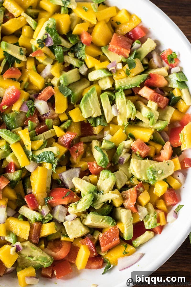 Close-up of a bowl of freshly mixed Mango Avocado Salsa, showcasing its vibrant colors and chunky texture.