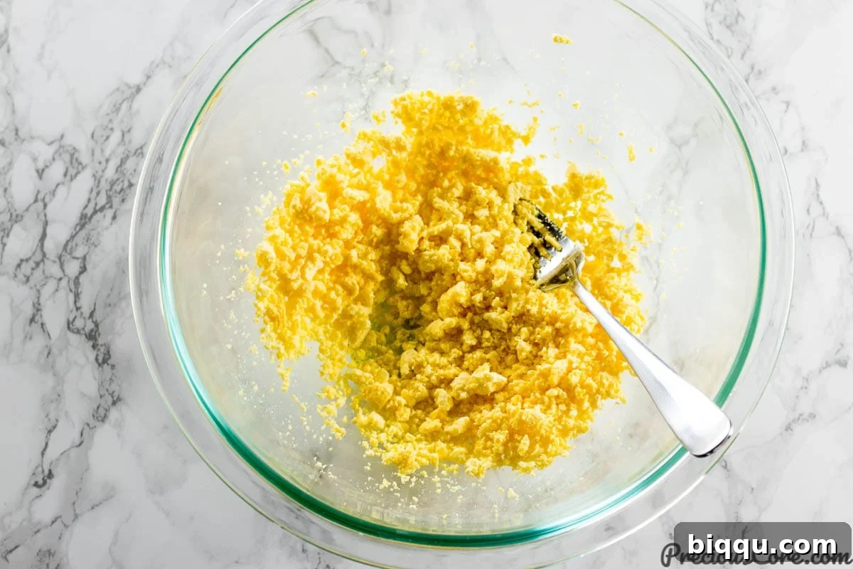 Mashing egg yolks for deviled eggs