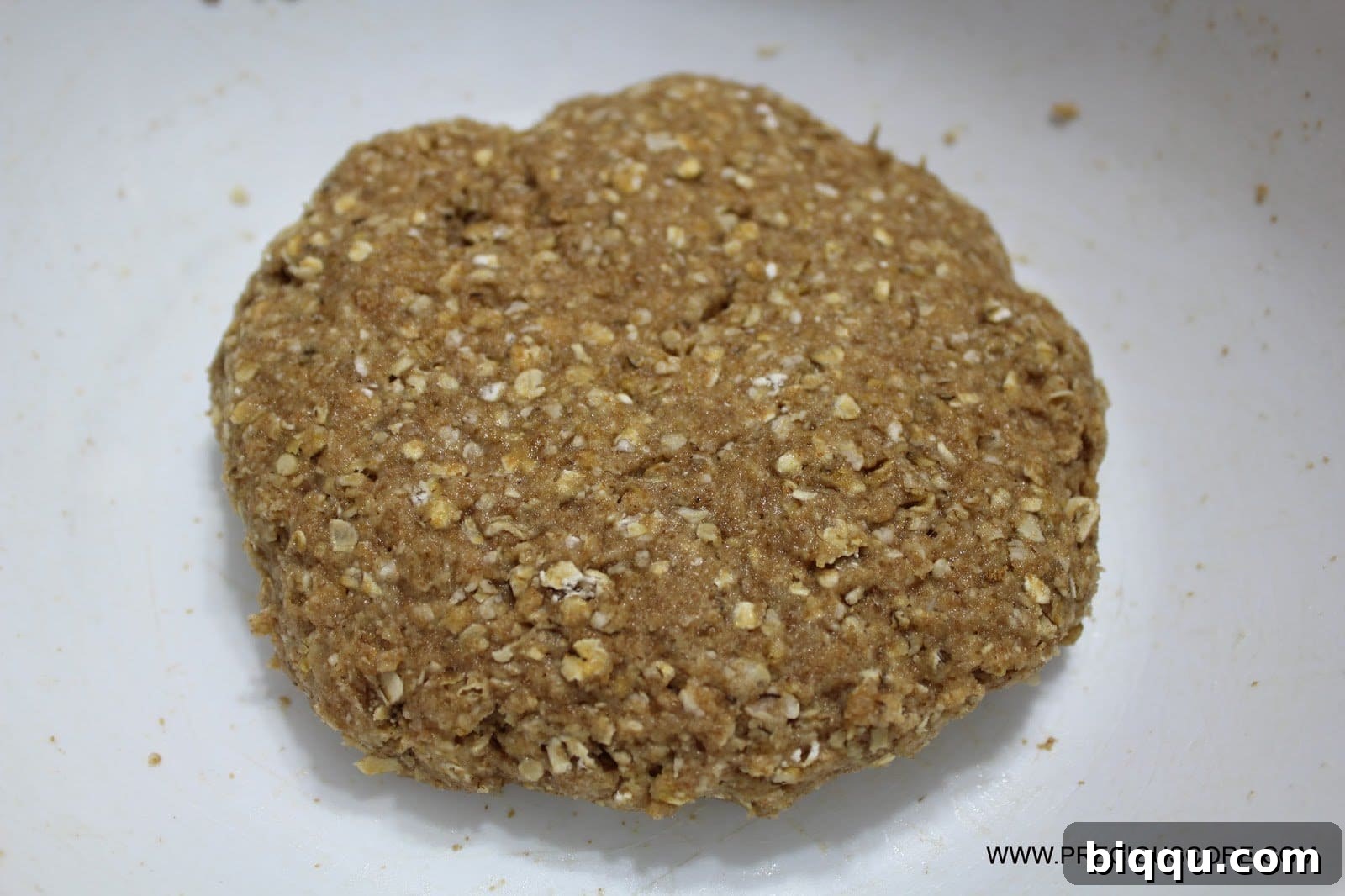 Shaping healthy fruit pizza crust dough on a pizza pan.