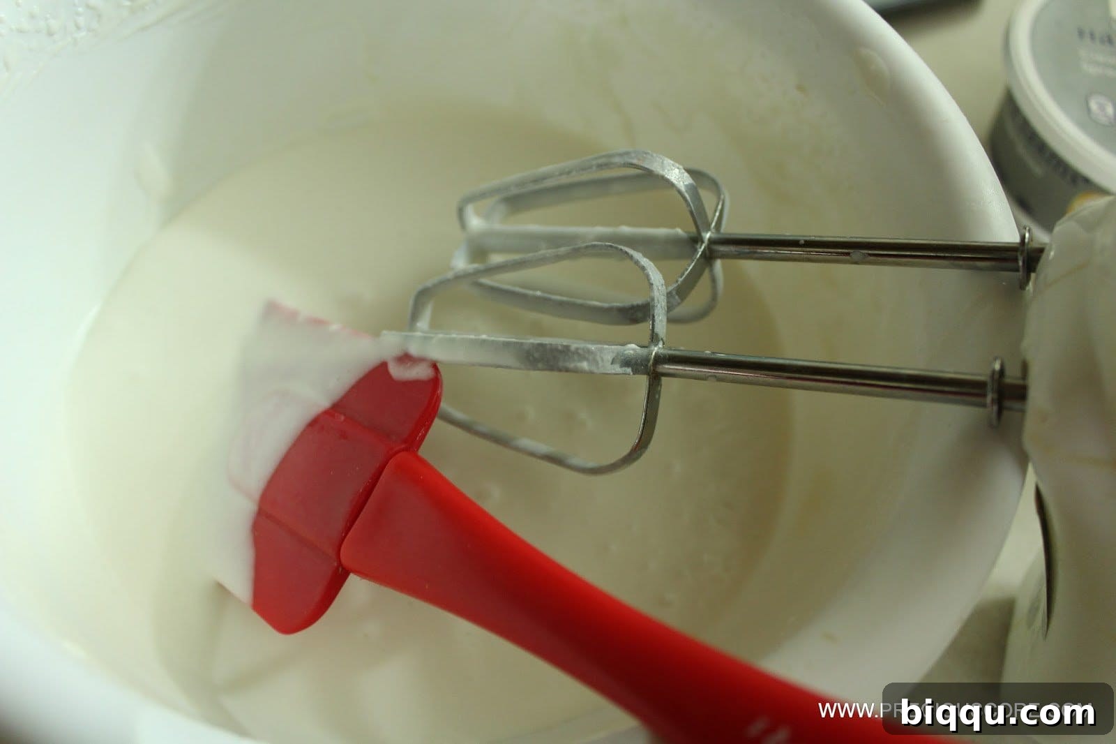 Beating coconut cream, trying to achieve a frosting consistency.