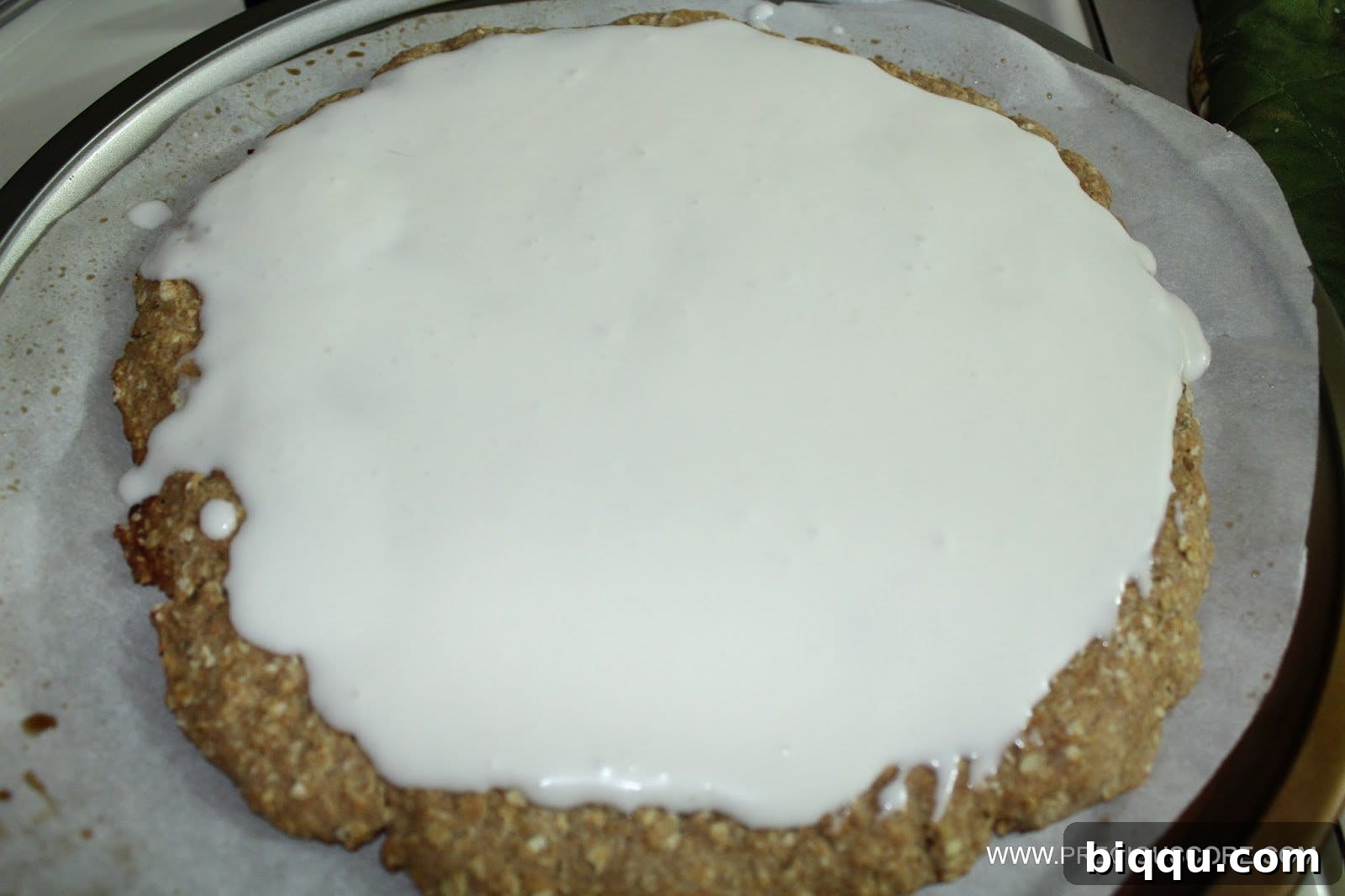 Coconut cream sauce spread evenly over the baked fruit pizza crust.