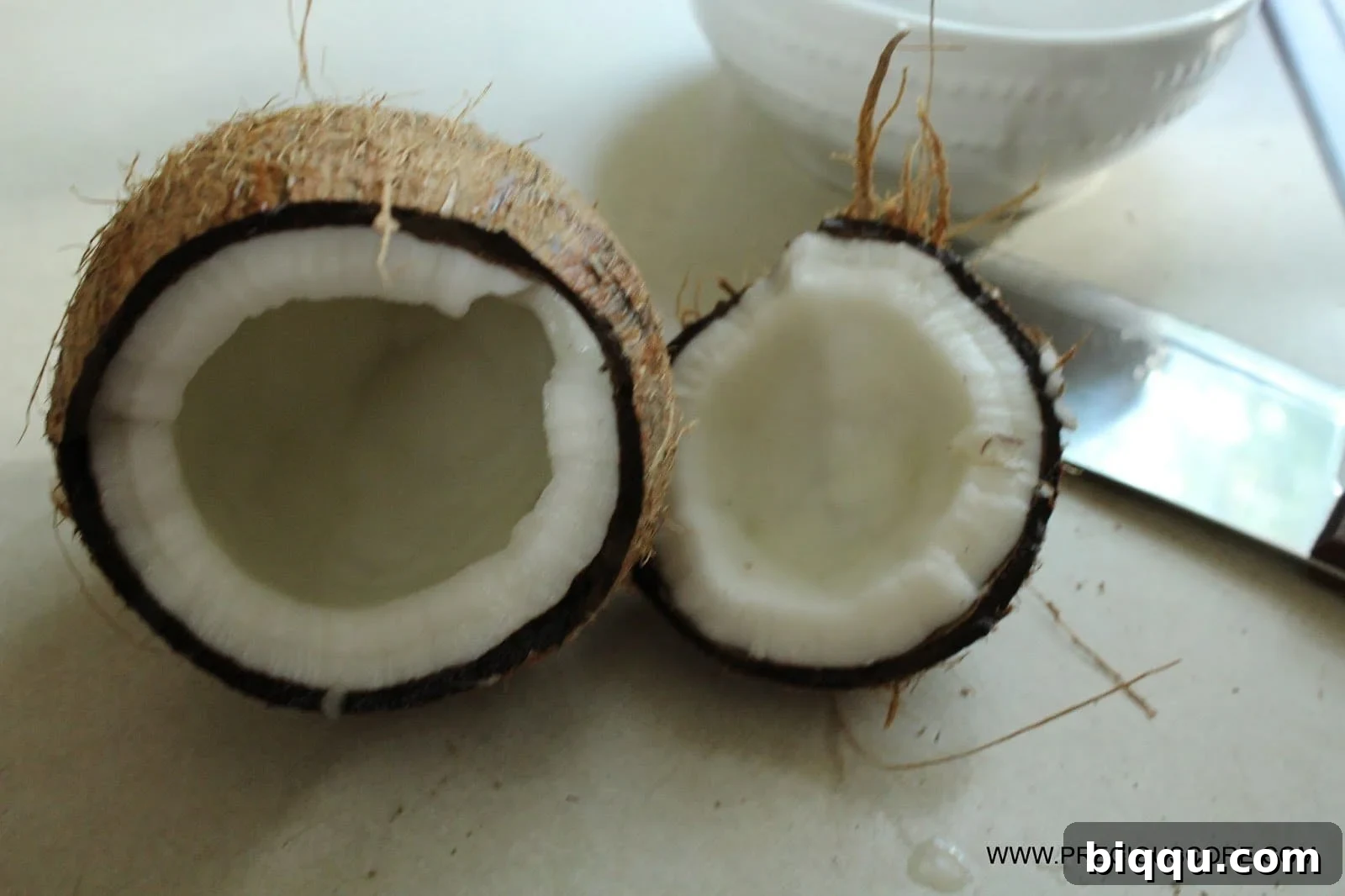 Fresh coconut flesh removed from shell, ready for shredding.