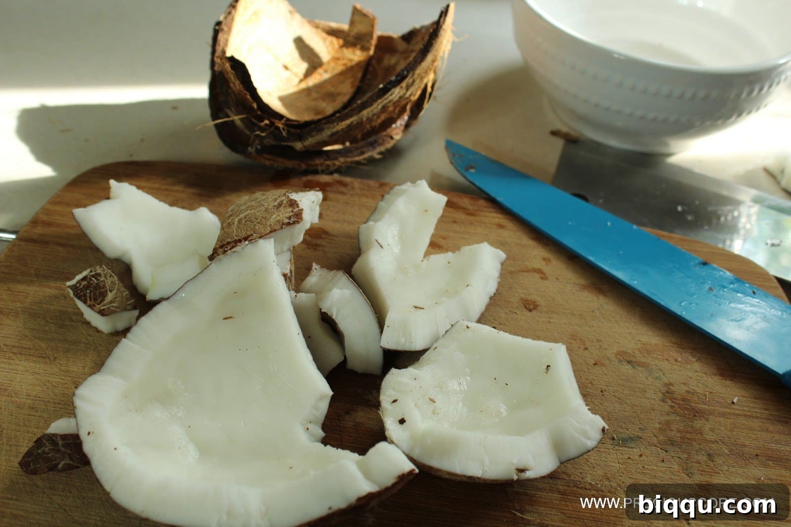 Shredding fresh coconut for homemade snack.