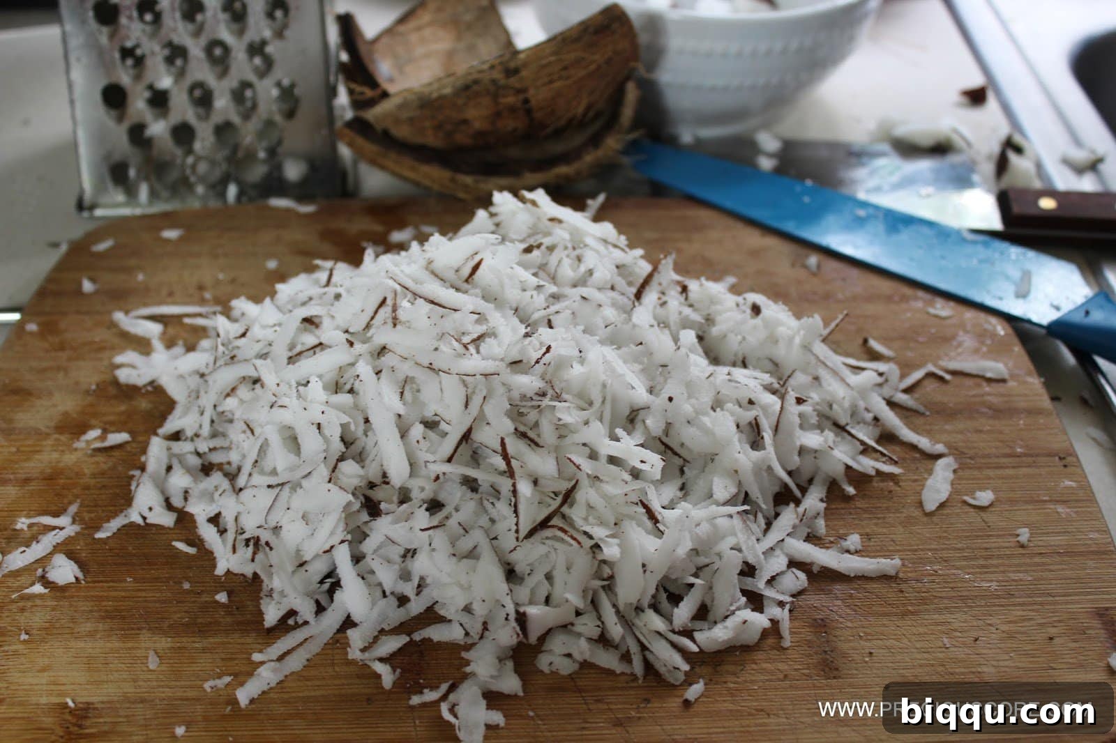 Eating fresh coconut shreds while preparing them.