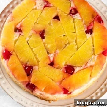 A beautifully presented Pineapple Upside Down Cake on a plate, ready to be served.