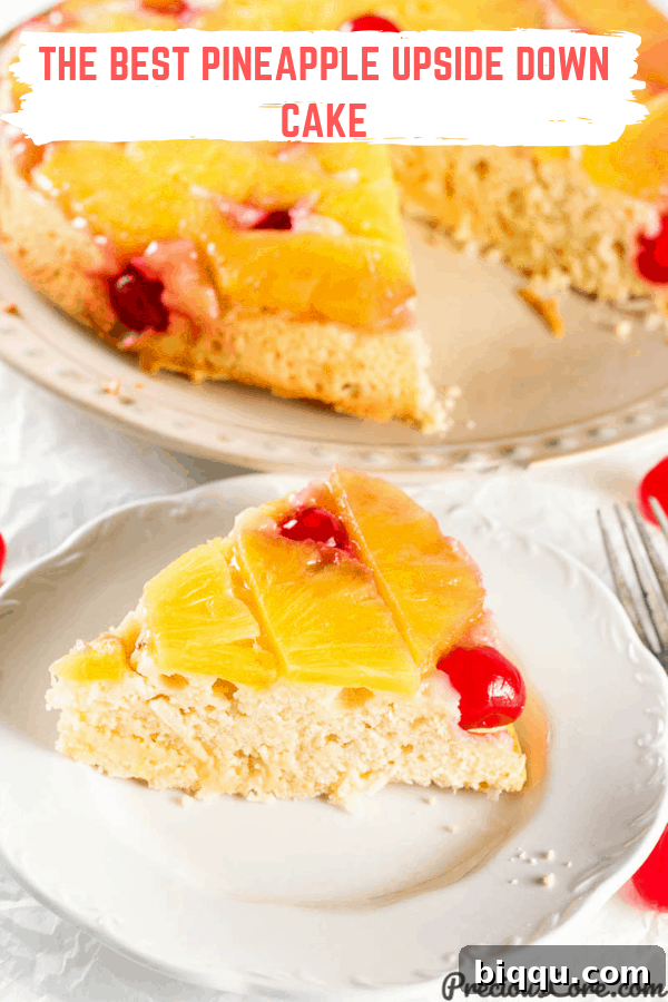 A stunning top-down view of the Pineapple Upside Down Cake on a pristine white plate, beautifully garnished, and ready to be sliced and served for a special occasion.
