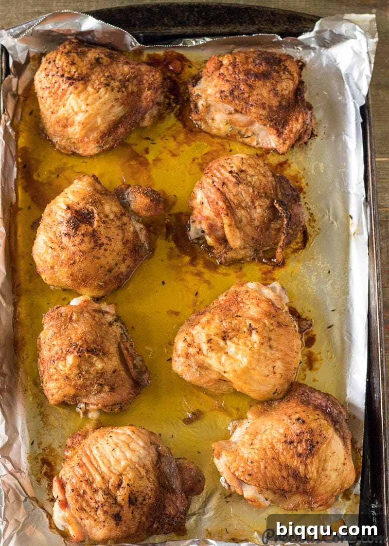 just baked chicken thighs on a baking sheet