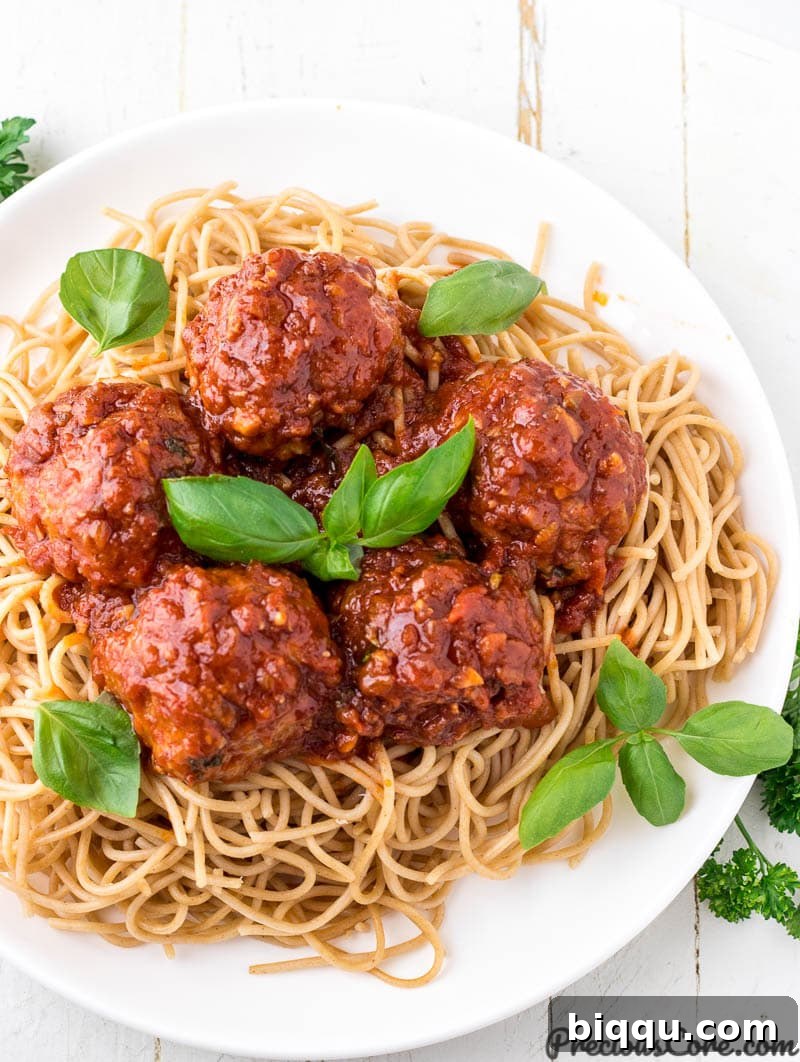 Chicken meatballs served over spaghetti, ready to be enjoyed.