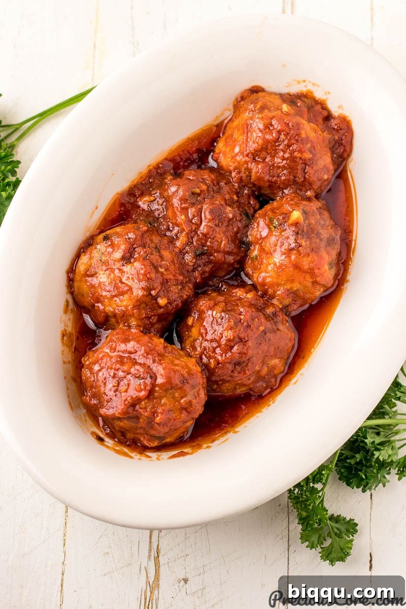 Serving bowl featuring tender chicken meatballs bathed in a rich, homemade tomato sauce.