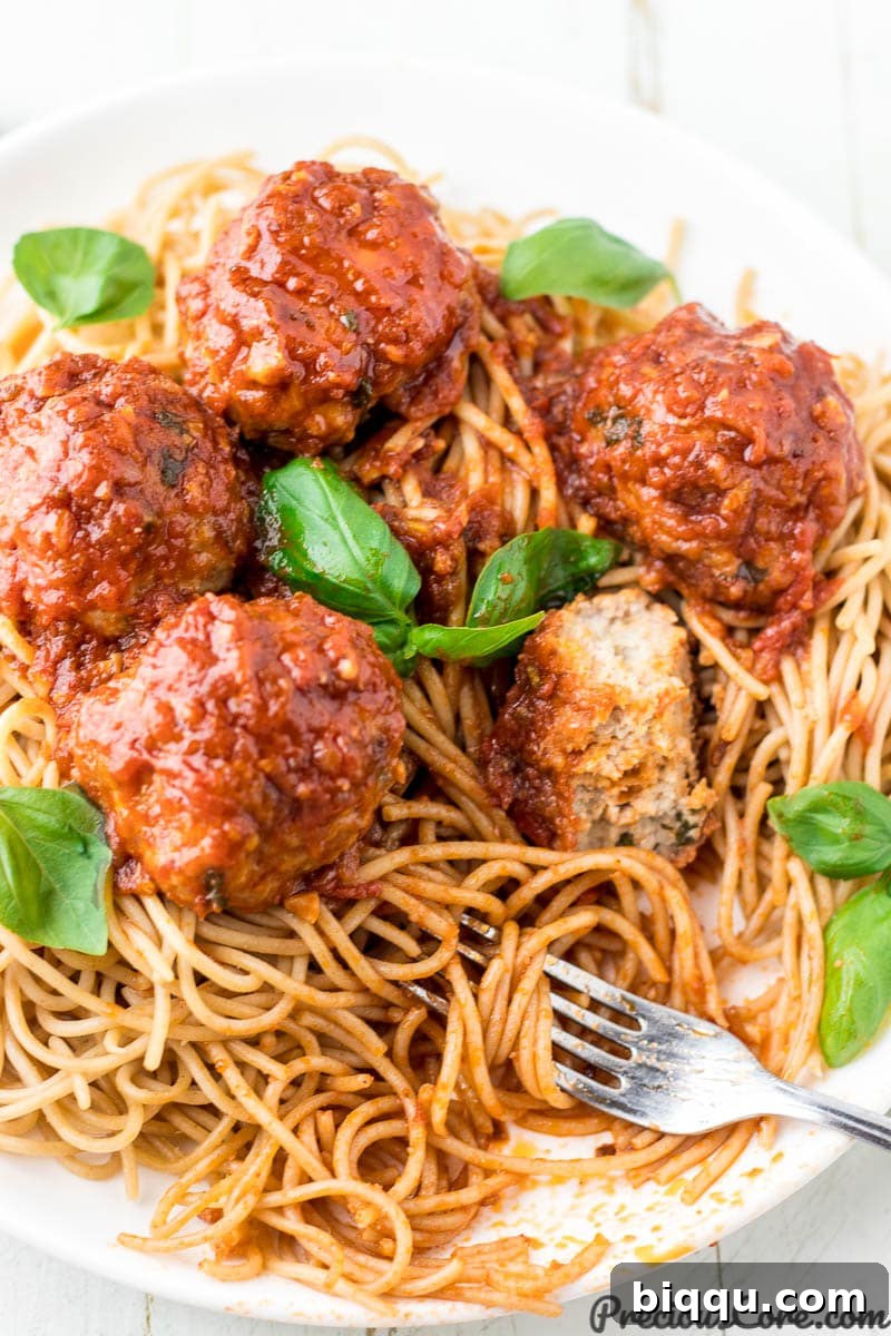 Delicious chicken meatballs served over a bed of spaghetti, coated in rich tomato sauce.