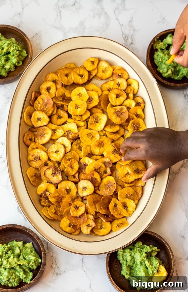 Crispy plantain chips artfully arranged on a tray, perfect for a healthy and flavorful snack.