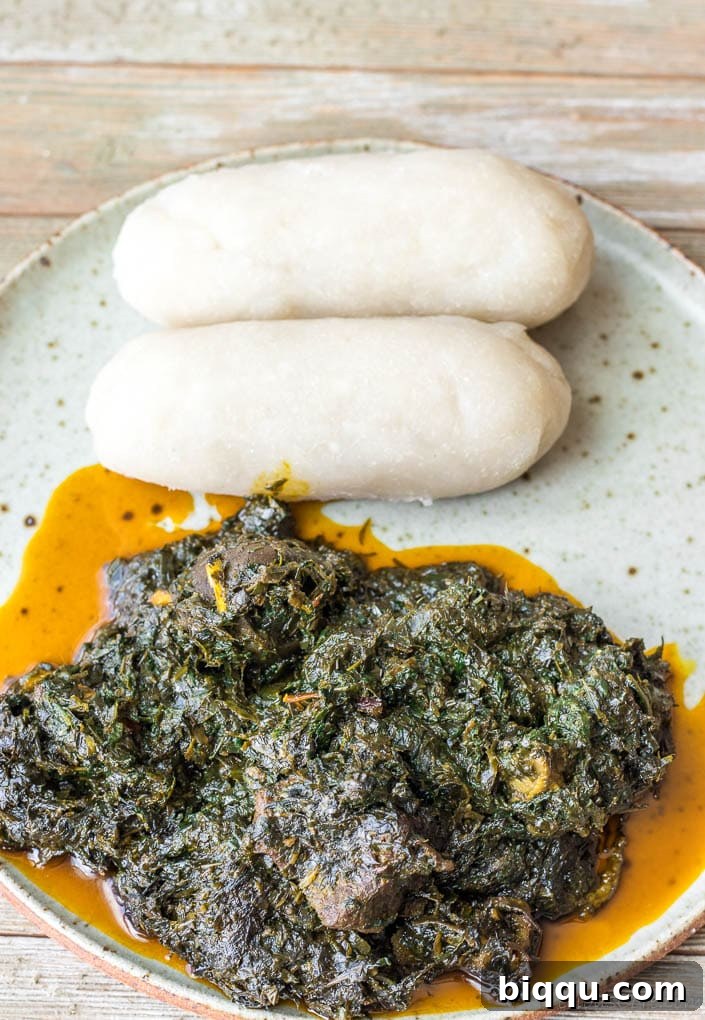 A traditional Cameroonian dish of Fufu and Eru, presented on a plate, rich with cultural flavors.