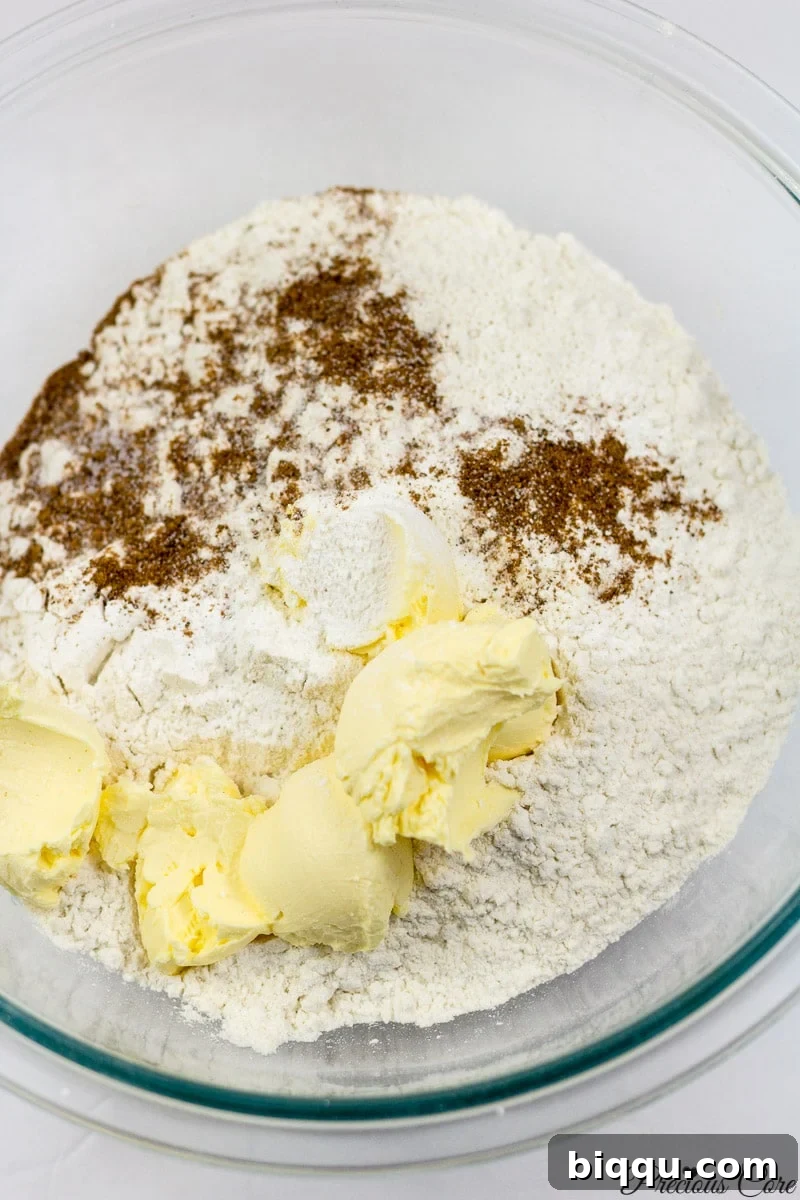 Cameroon doughnuts dry ingredients including flour, baking powder, nutmeg, salt, and margarine in a bowl.