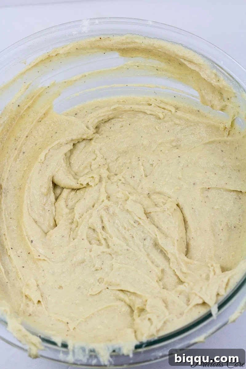 Smooth doughnut batter in a mixing bowl, ready for the next step.