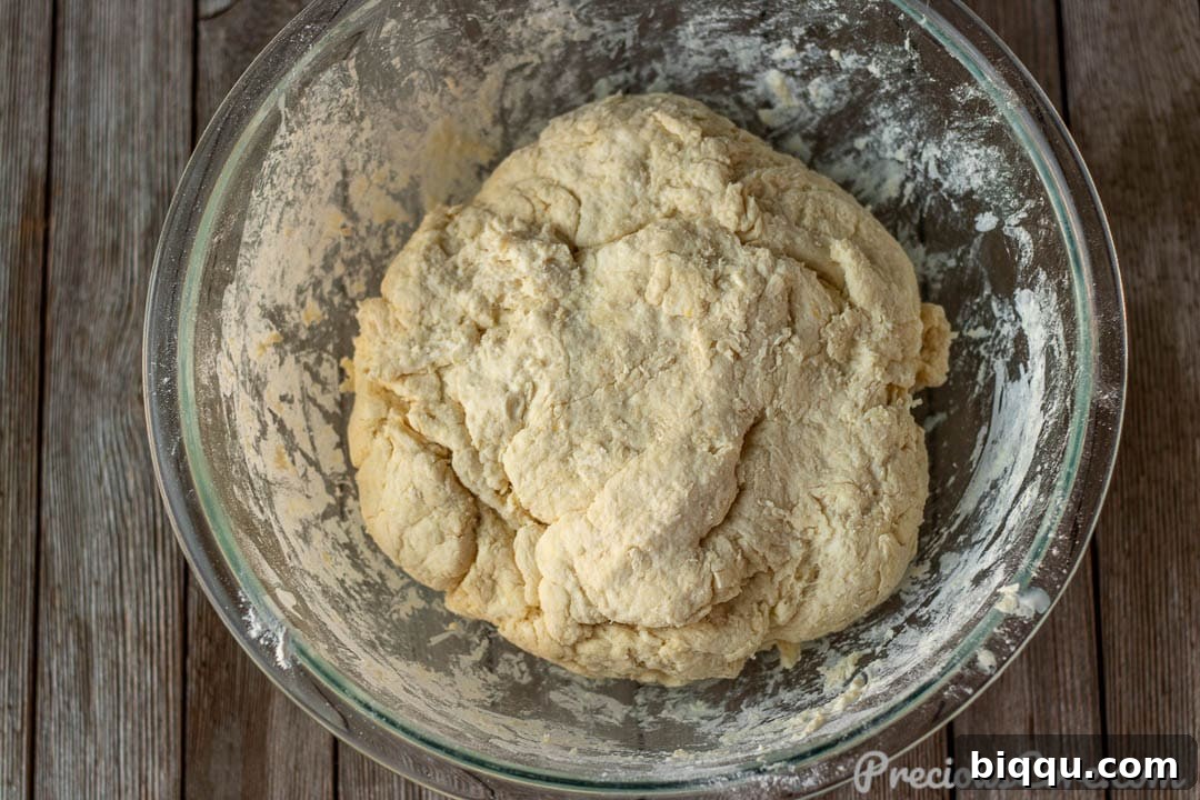 Homemade biscuit dough forming in a bowl after buttermilk has been added.