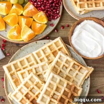 Homemade Waffles on a plate with whipped cream on the side