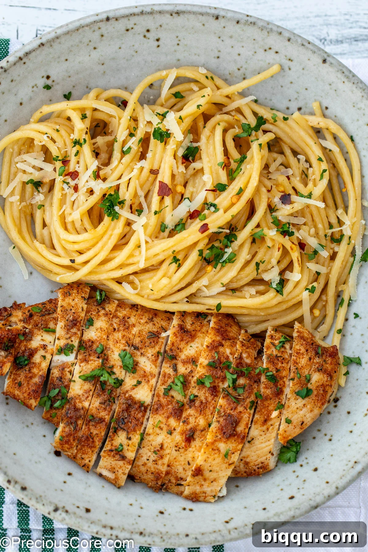 Garlic butter pasta and chicken breast in a bowl.