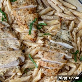 Creamy garlic parmesan pasta topped with chicken.