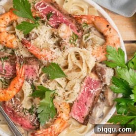 Creamy pasta topped with juicy steak and shrimp.