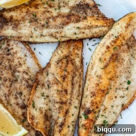 Pan Seared Sea Bass filets on a white plate.