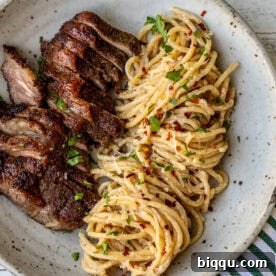 Steak and Pasta with homemade garlic cream sauce.