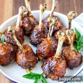 Plate of baked and glazed chicken lollipops.