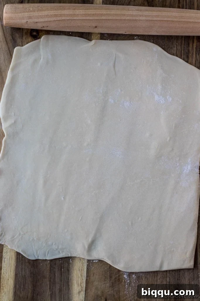 A sheet of puff pastry, perfectly rolled out and ready to top the apples