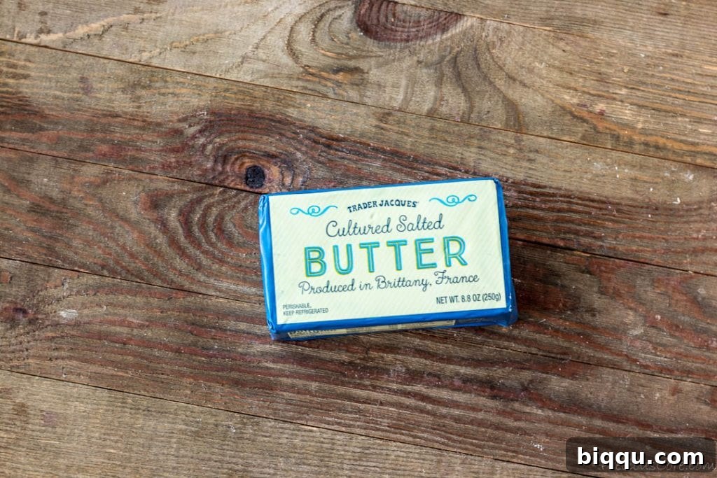 Block of exquisite French butter on a rustic wooden board