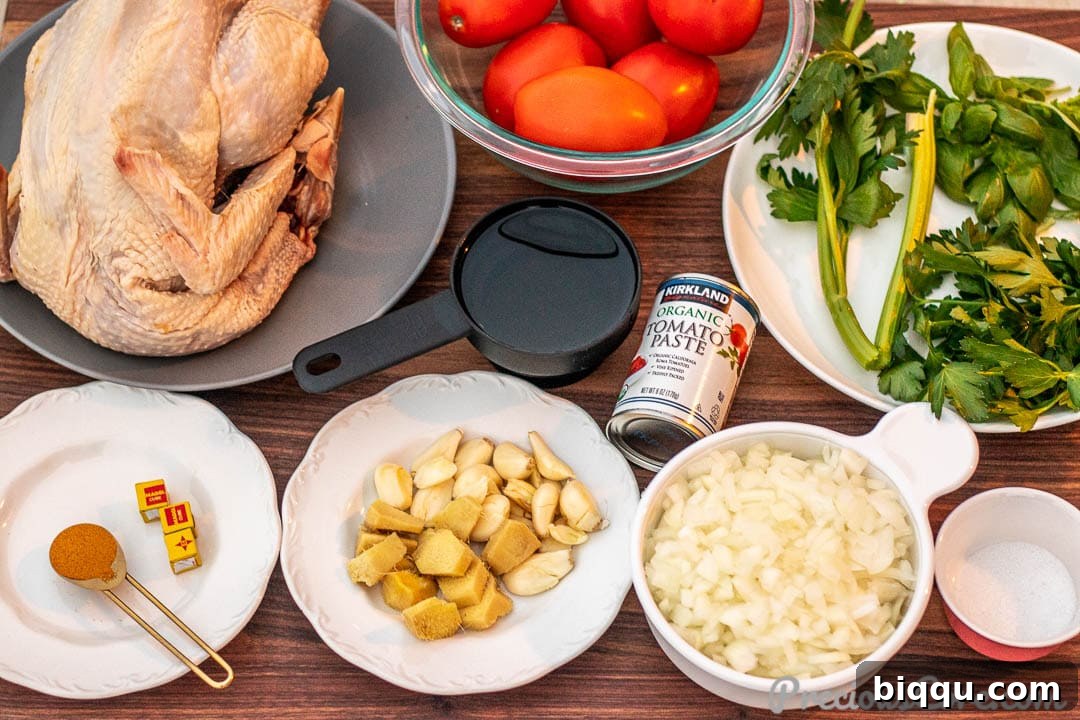 Various fresh ingredients for African chicken stew laid out on a chopping board.