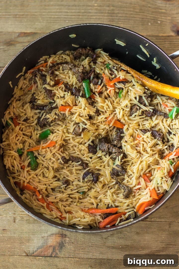 The finished one-pot Beef Fried Rice, perfectly cooked with tender beef and vibrant vegetables, resting in the pot.